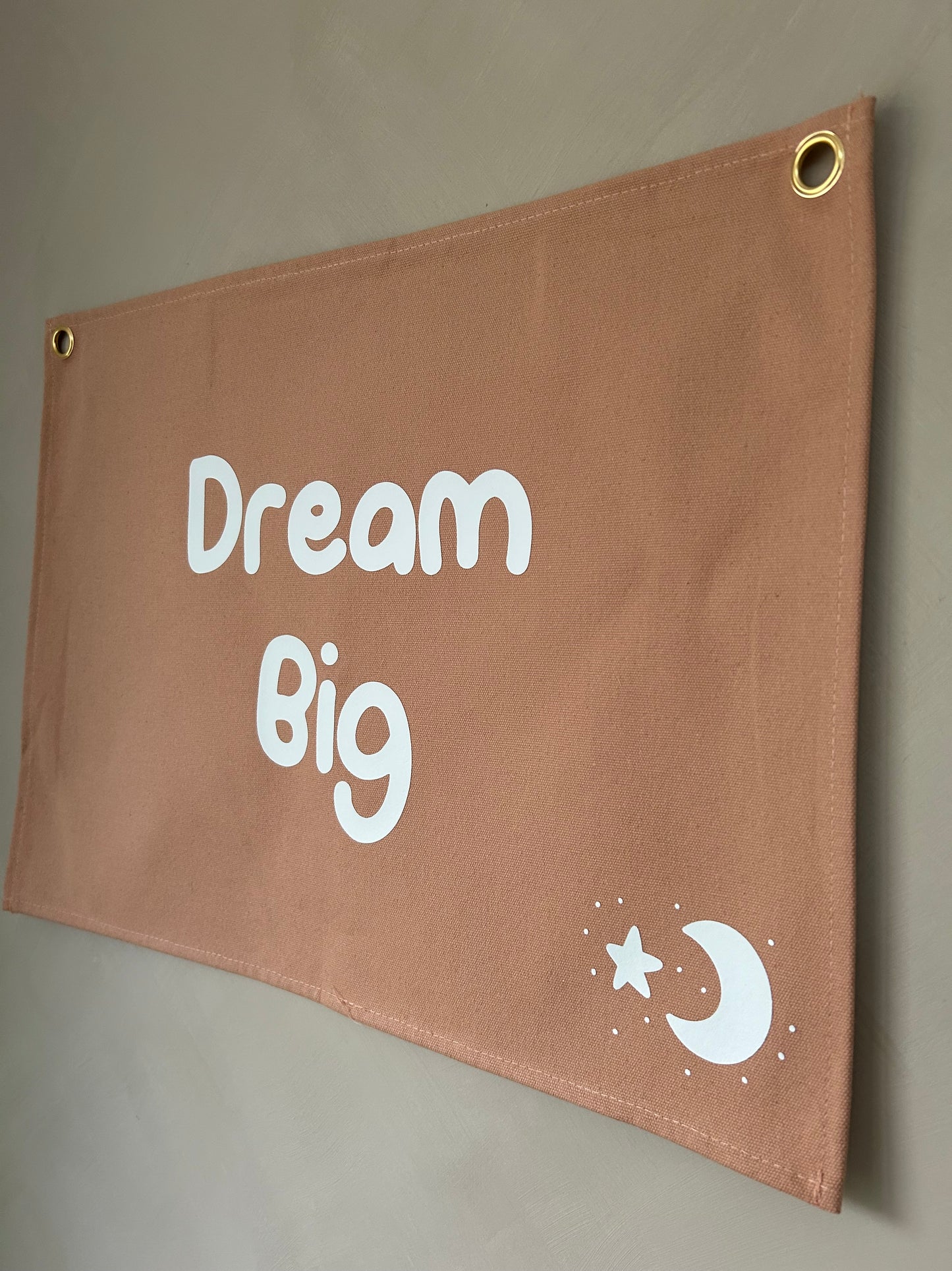 dusty pink wall flag with dream big on it