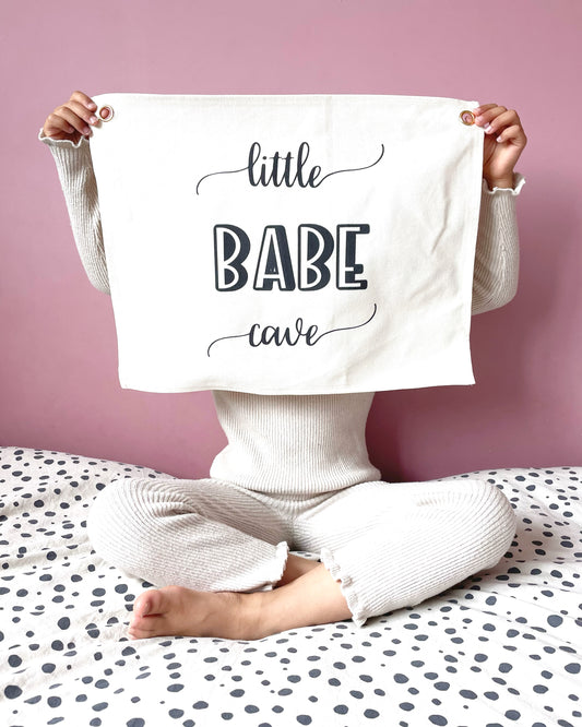 wall flag with little babe cave written on it