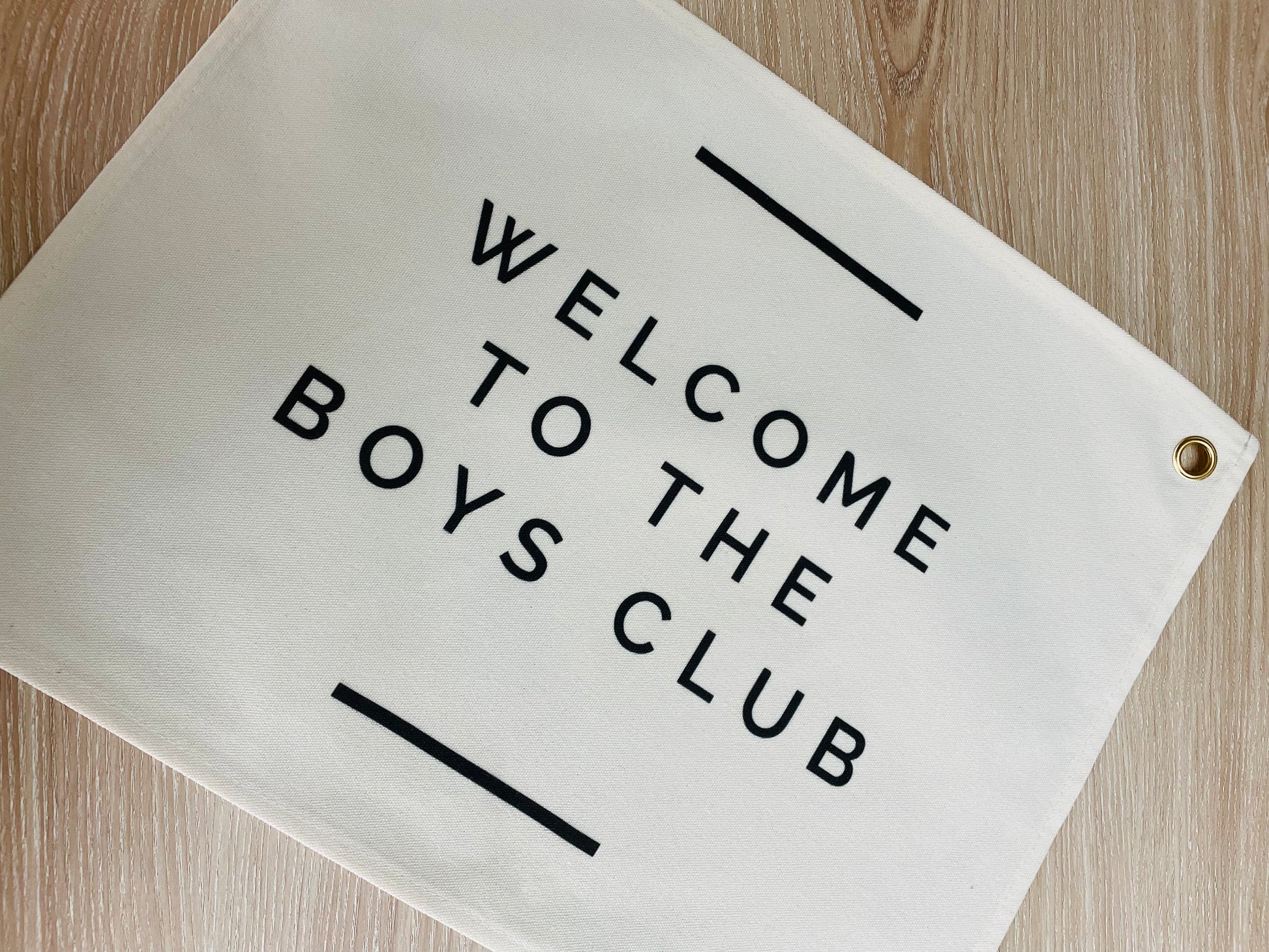 wall flag with welcome to the boys club on it